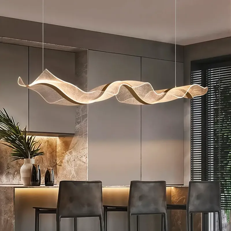 Gold wave pendant lamp with aluminum construction hanging over dining table